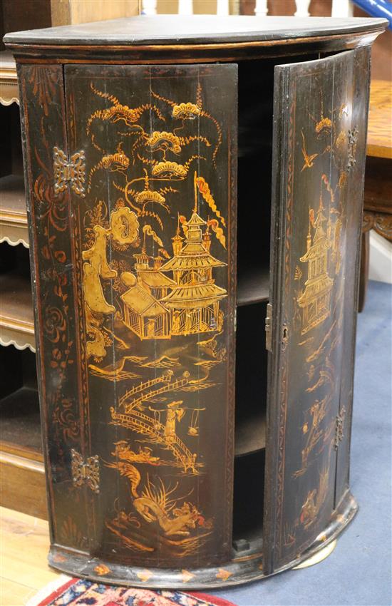 A late 18th century East Anglian chinoiserie lacquered bow fronted hanging corner cupboard W.65cm